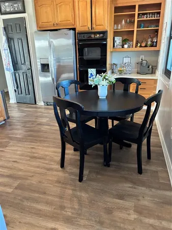 a kitchen with stainless steel appliances a sink cabinets and wooden floor