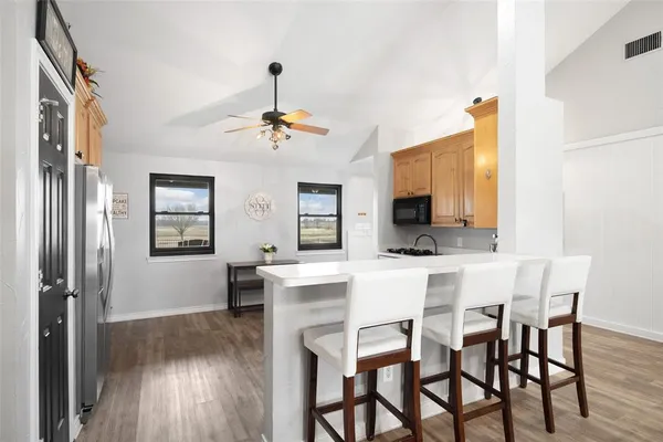 a spacious bedroom with a bed and a ceiling fan