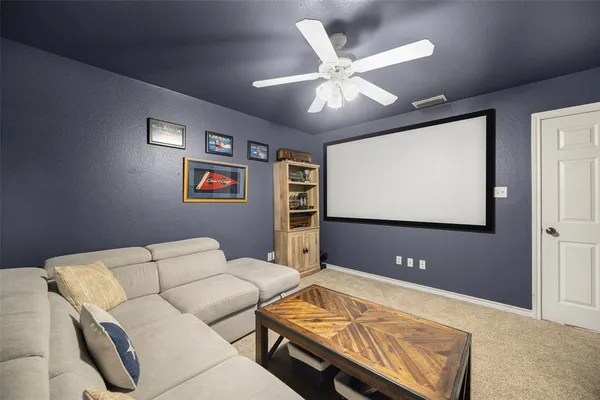 a bedroom with a bed flat screen tv and window