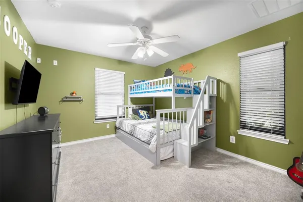 a spacious bedroom with a bed and a chandelier