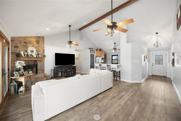 a living room with furniture a fireplace and a flat screen tv