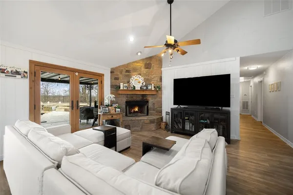 a living room with furniture and kitchen view