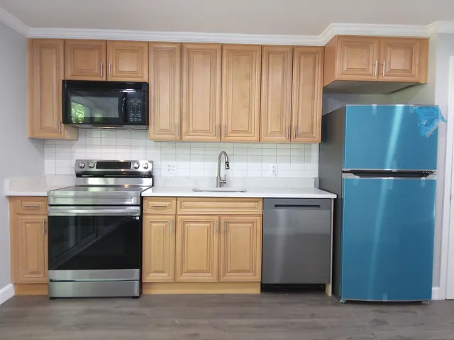 a kitchen with granite countertop a stove and a sink