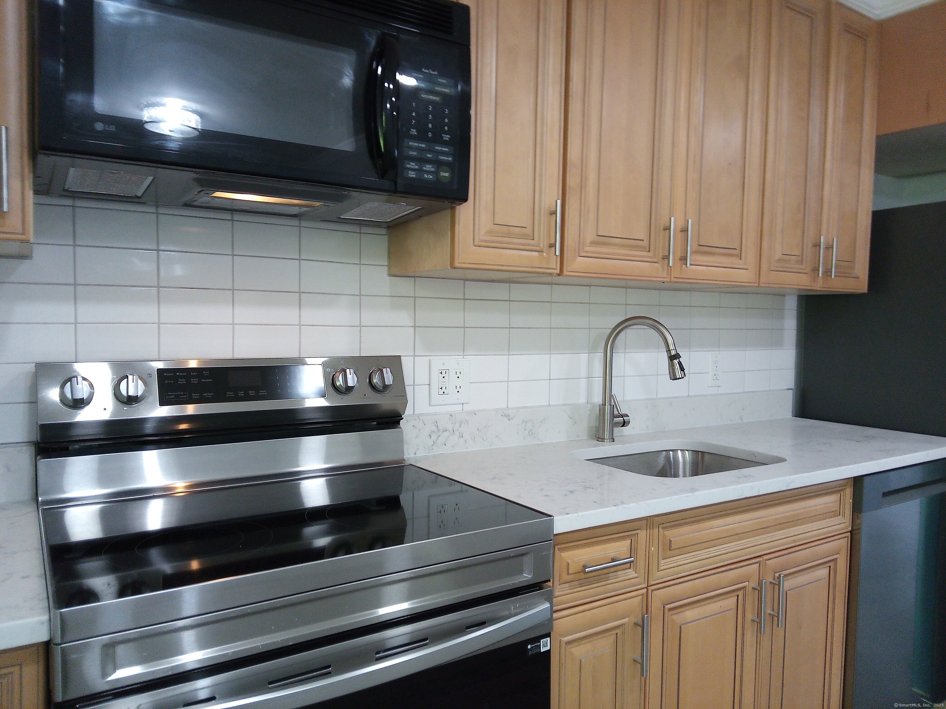 74 Washington Road, Unit 16 Woodbury, CT 06798 - Photo 12 of 25 a kitchen with granite countertop a stove and a sink