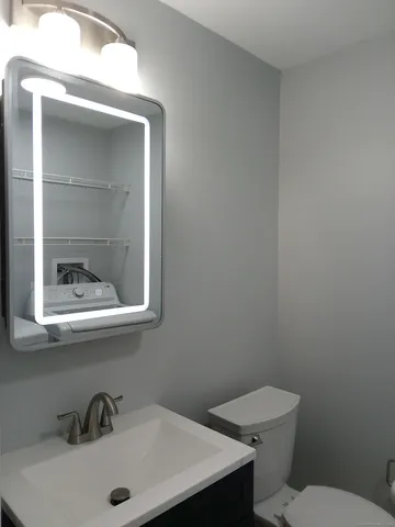 a bathroom with a toilet and a sink