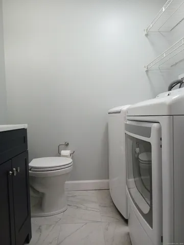 a view of a livingroom with wooden floor and staircase