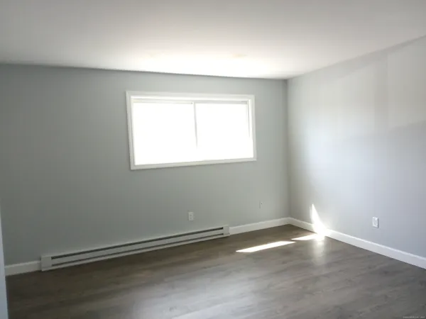 an empty room with wooden floor