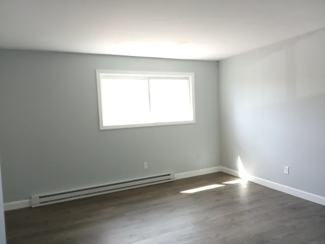 an empty room with wooden floor