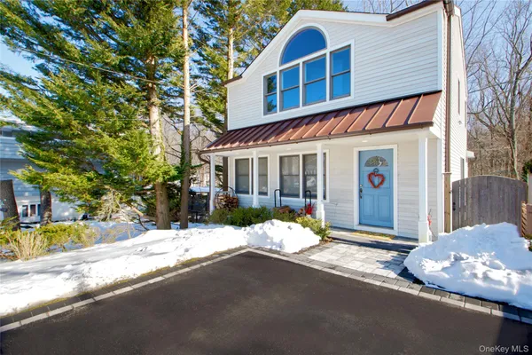 a front view of a house with a yard outdoor seating and garage