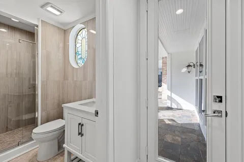 a view of a hallway with wooden floor and entryway