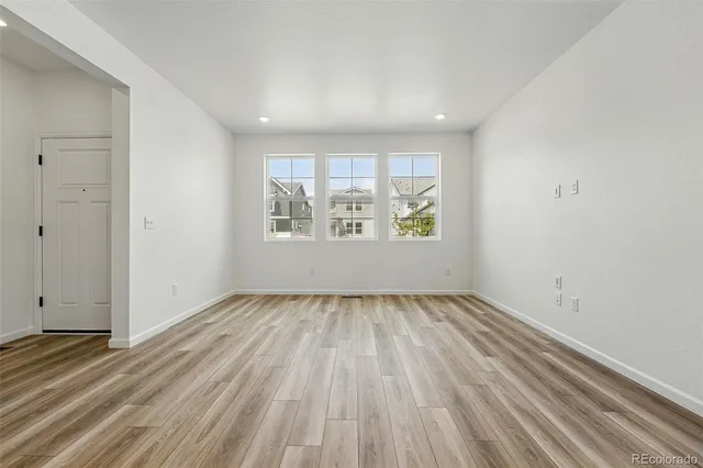 wooden floor in an empty room with a window