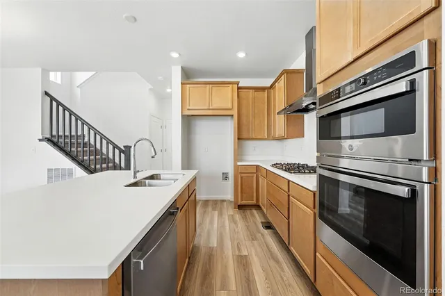 a kitchen with a sink stove and microwave