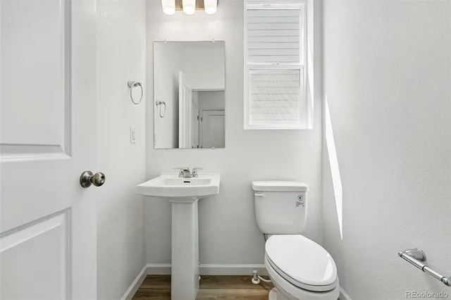 a white toilet sitting next to a bathroom sink