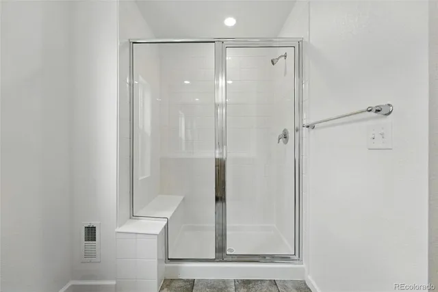 a bathroom with a shower and a sink