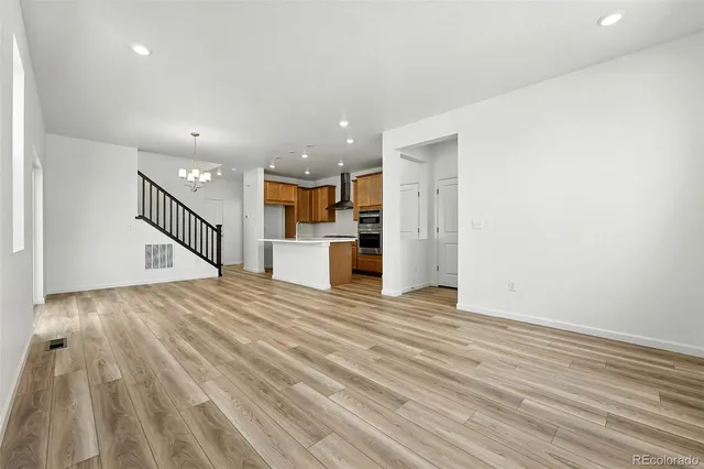 a view of a kitchen with wooden floor and a sink