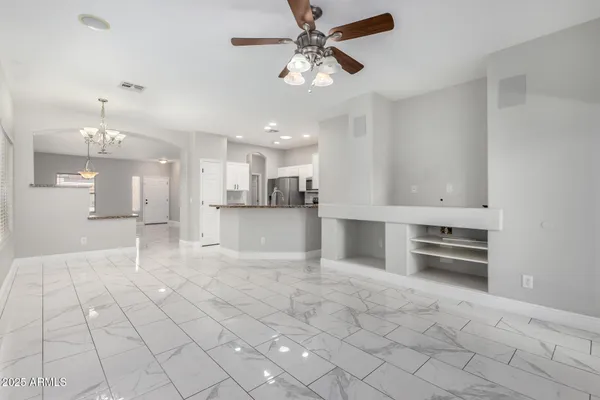 a large white kitchen with cabinets