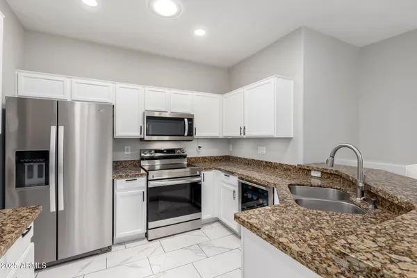 a kitchen with a sink a stove and refrigerator