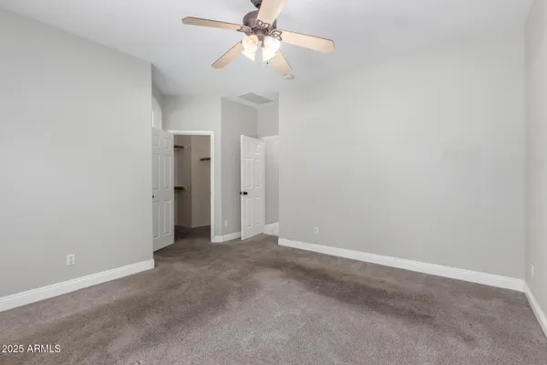 a view of an empty room with a fan
