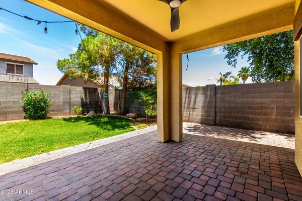 a view of a house with a small yard and floor to ceiling window