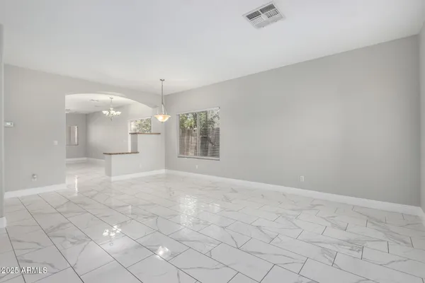 an empty room with windows and entrance