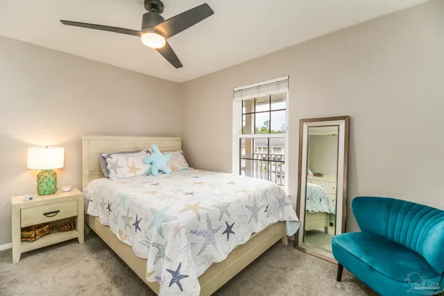 a bedroom with a bed a couch and a window