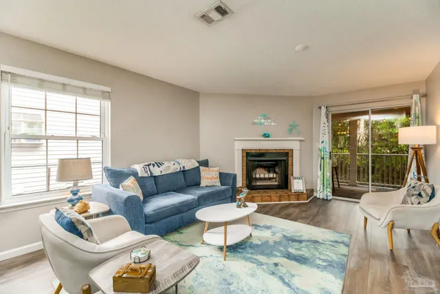 a living room with furniture and a fireplace