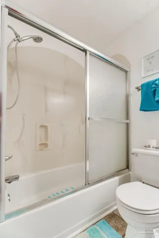 a bathroom with a shower and a toilet