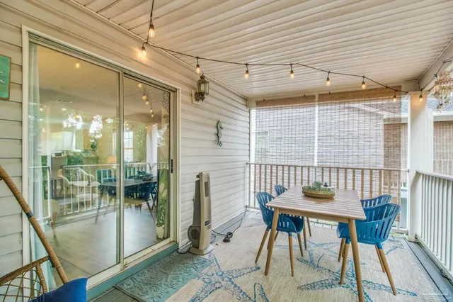 a view of a dining room with furniture large windows and wooden floor