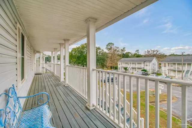 a view of a balcony with wooden floor