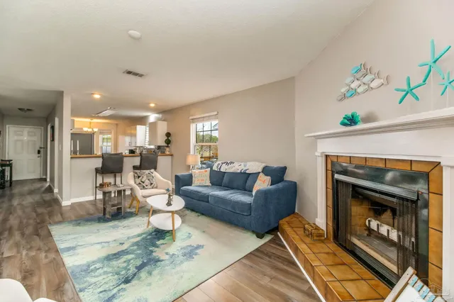 a living room with furniture and a fireplace