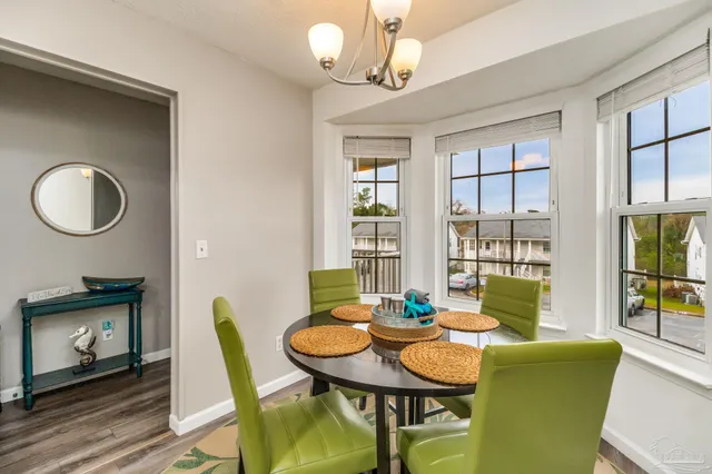 a view of a dining room with furniture and a window