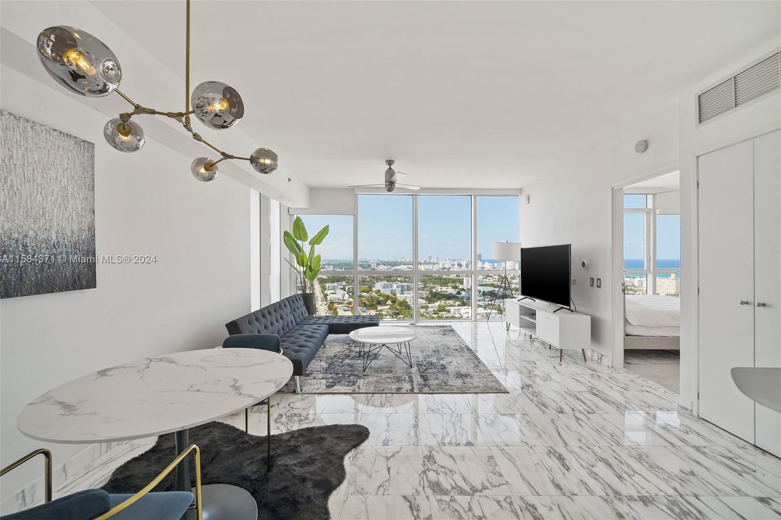 a living room with furniture a flat screen tv and a window