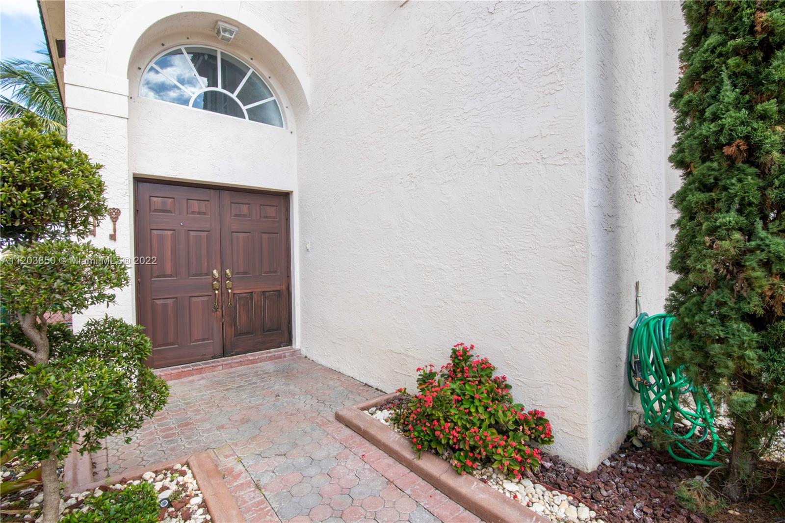 14821 Southwest 20th Street Miramar, FL 33027 - Photo 12 of 50 a front view of a house with a yard