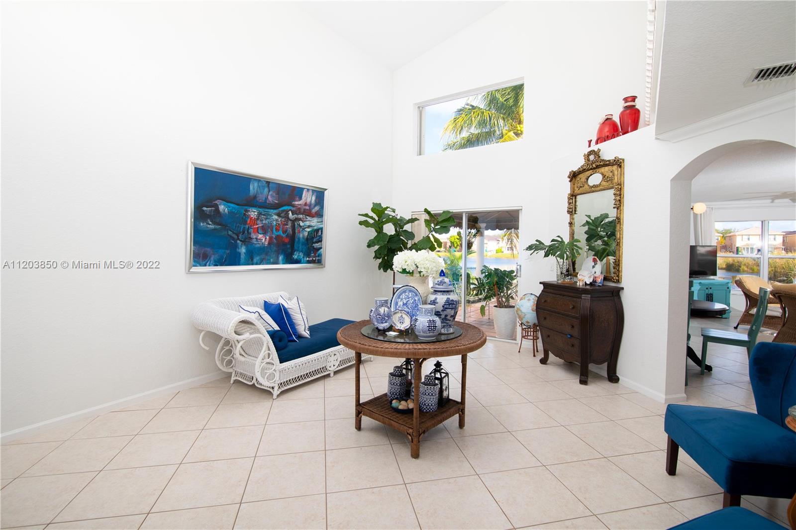 14821 Southwest 20th Street Miramar, FL 33027 - Photo 13 of 50 a living room with furniture and flowers