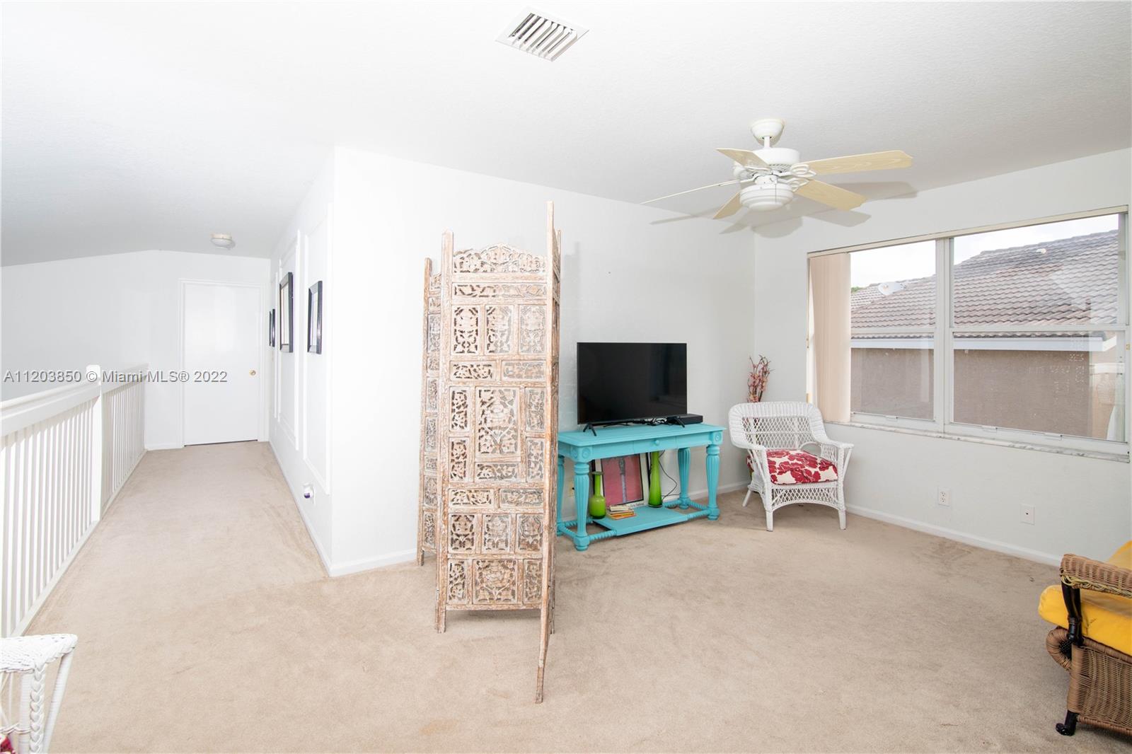14821 Southwest 20th Street Miramar, FL 33027 - Photo 28 of 50 a view of a livingroom with furniture and a flat screen tv