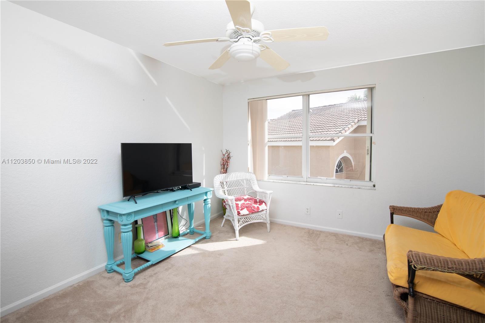 14821 Southwest 20th Street Miramar, FL 33027 - Photo 29 of 50 a living room with furniture and a flat screen tv