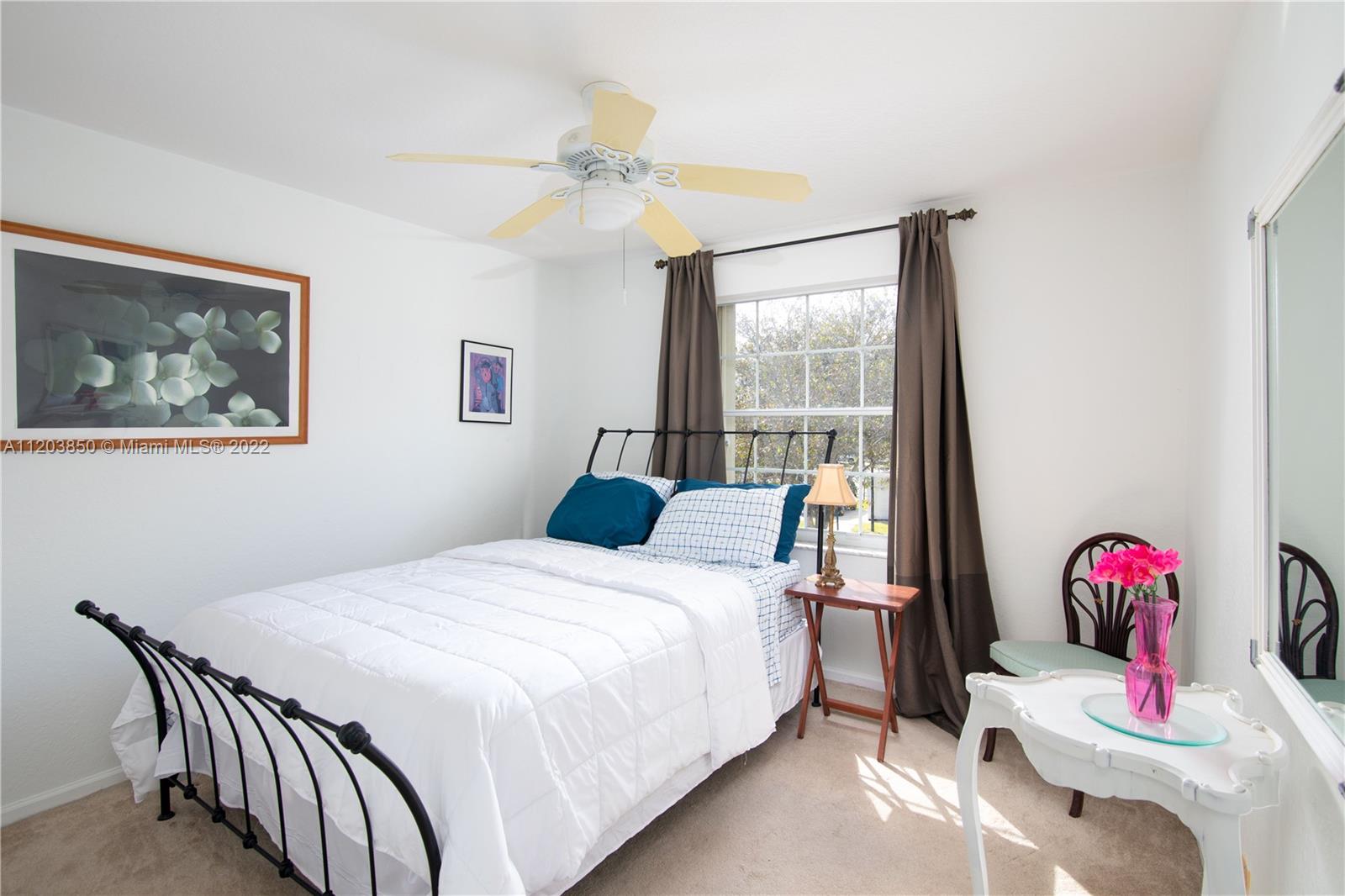 14821 Southwest 20th Street Miramar, FL 33027 - Photo 31 of 50 a bedroom with a bed and a chandelier
