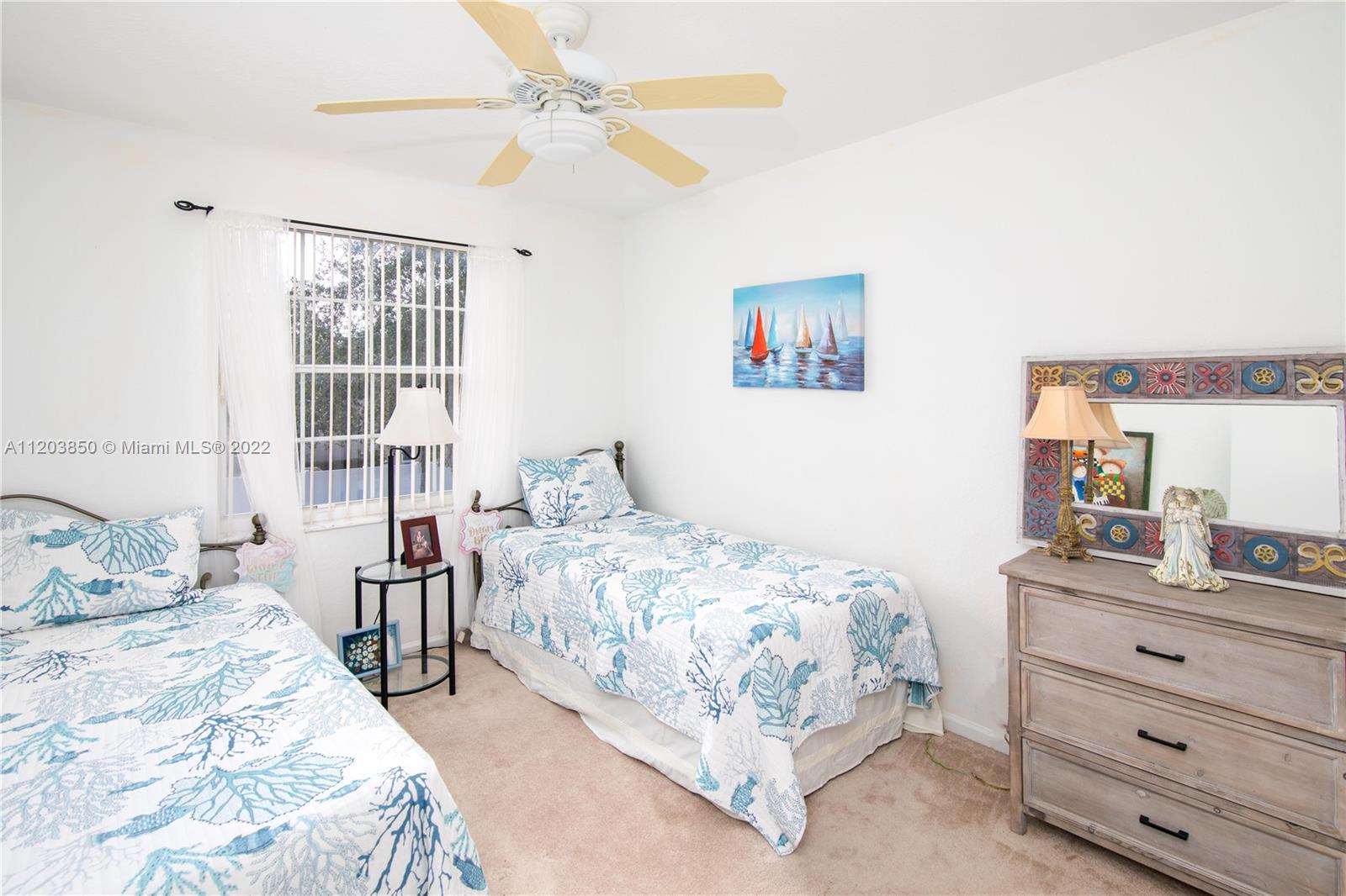 14821 Southwest 20th Street Miramar, FL 33027 - Photo 32 of 50 a bedroom with a bed and a window