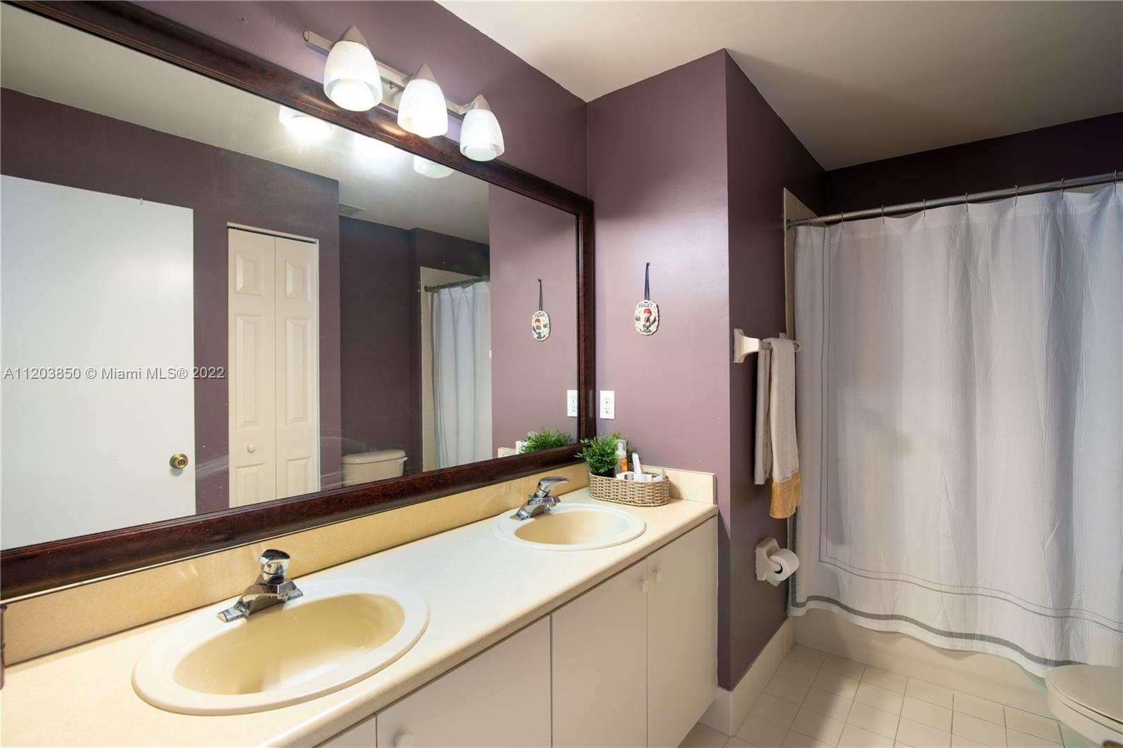 14821 Southwest 20th Street Miramar, FL 33027 - Photo 33 of 50 a bathroom with a sink double vanity and a mirror