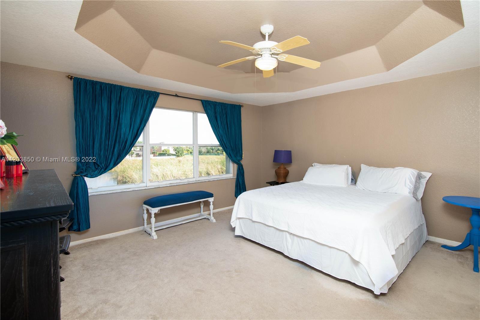 14821 Southwest 20th Street Miramar, FL 33027 - Photo 5 of 50 a bedroom with a bed and a chandelier