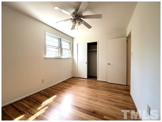 3309 Leonard Street Raleigh, NC 27607 - Photo 11 of 21 an empty room with wooden floor and windows