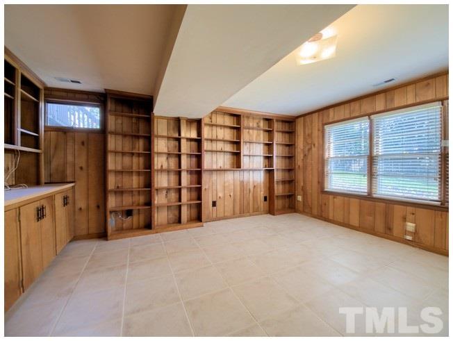 3309 Leonard Street Raleigh, NC 27607 - Photo 14 of 21 a view of an empty room with a fireplace and cabinets