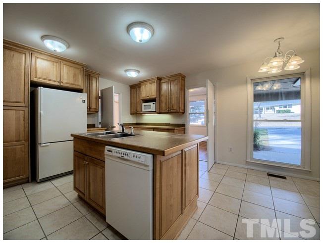 3309 Leonard Street Raleigh, NC 27607 - Photo 3 of 21 a kitchen with stainless steel appliances granite countertop a sink and a refrigerator