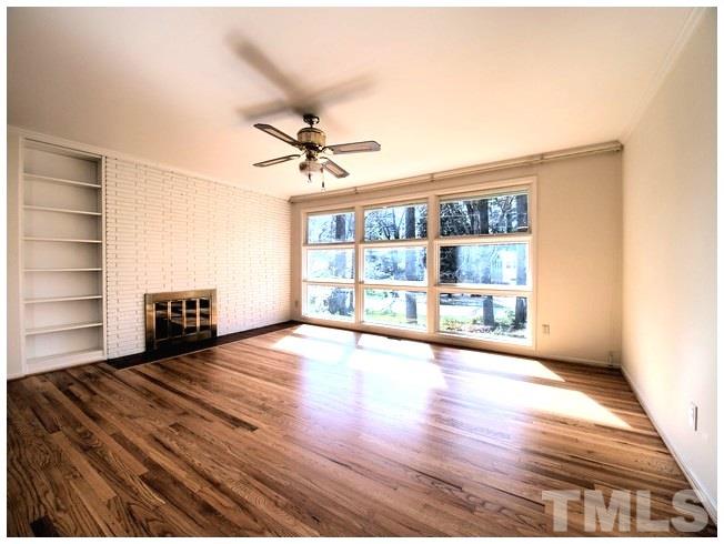 3309 Leonard Street Raleigh, NC 27607 - Photo 7 of 21 a view of an empty room with a window and wooden floor