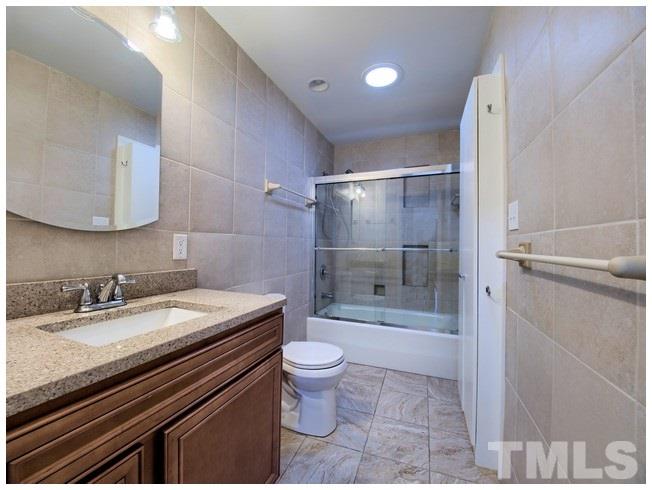3309 Leonard Street Raleigh, NC 27607 - Photo 9 of 21 a bathroom with a sink a toilet and shower