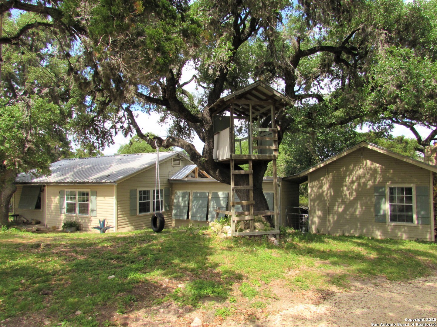 512 County Road 348 Concan, TX 78838 - Photo 8 of 39 a front view of a house with a yard