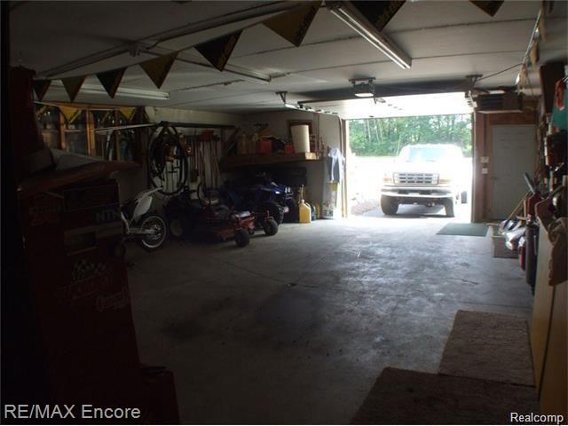 8629 Sashabaw Road Clarkston, MI 48348 - Photo 30 of 34 Lower two car garage with workshop