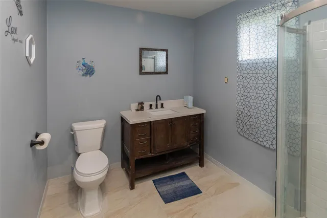 a bedroom with a bed and a night stand