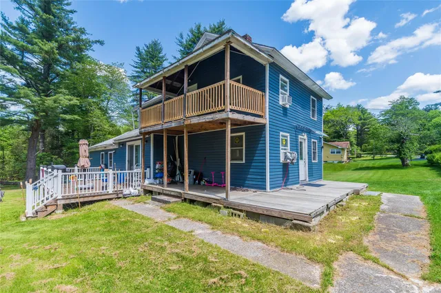 a front view of a house with swimming pool and porch