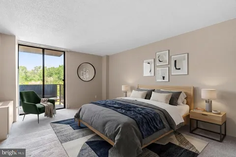 a bedroom with a large bed and a lamp next to a window